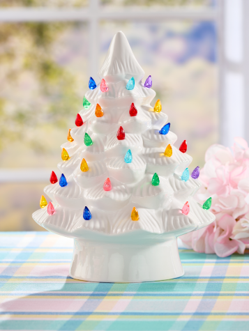 White ceramic tree with multicolored lightbulbs.