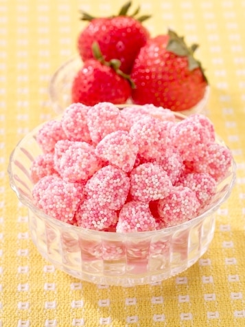 Strawberry gummies with pink nonpareil sprinkles.