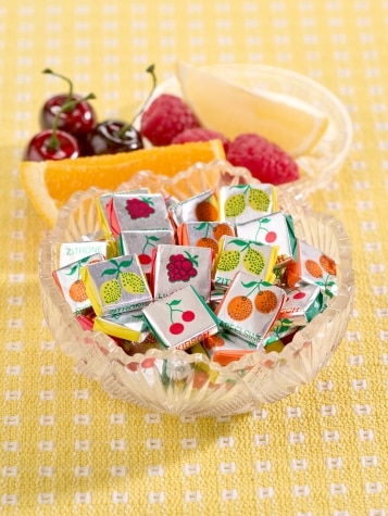 Individually wrapped assorted fruit chews in dish.