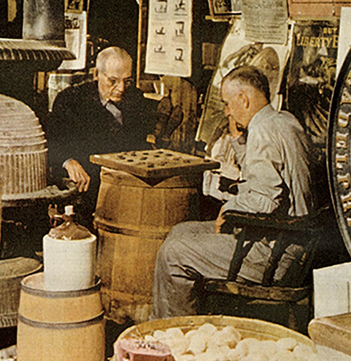 Gardner Lyman Orton and another gentleman playing checkers by a stove inside The Vermont Country Store.