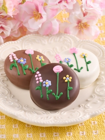 Chocolate covered cookies with floral decorations.